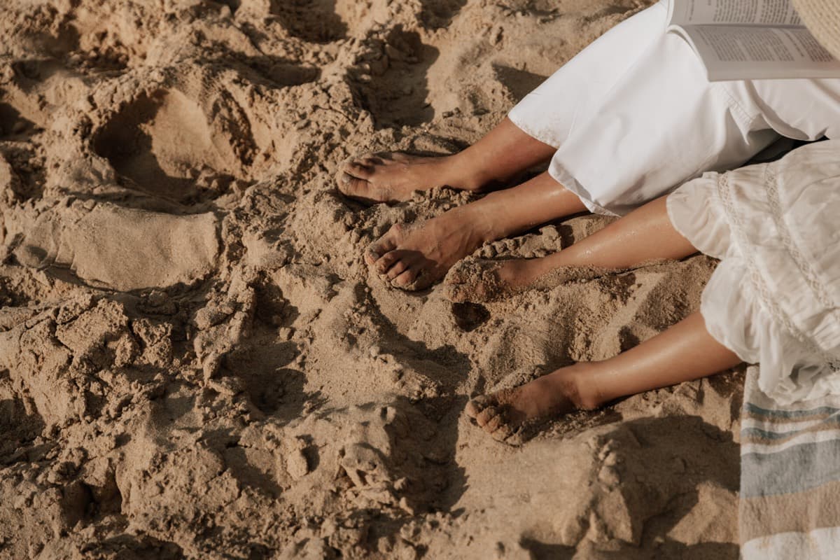 Blote voeten op het strand — oorzaken van kalknagels